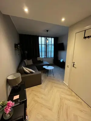 a living room with a couch and a table at ‘T Singeltje in Leiden