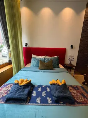 a bedroom with a bed with towels on it at Boutique Amsterdam Homestay in Amsterdam