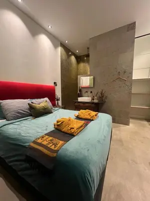 a bedroom with a large bed with a red headboard at Boutique Amsterdam Homestay in Amsterdam