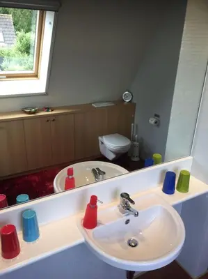 a bathroom with a sink and a mirror at Near Amsterdam, The Hague, Leiden and North Sea in Warmond