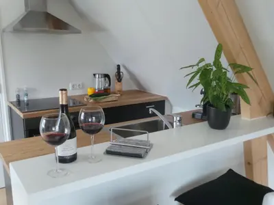 a kitchen with two glasses of wine on a counter at Top appartement in prachtige hart van Nederland Kortenhoef in Kortenhoef