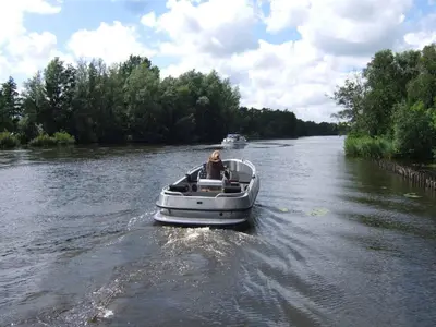 a person in a boat on a river at Top appartement in prachtige hart van Nederland Kortenhoef in Kortenhoef
