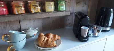 a counter with a plate of croissants and a cup of coffee at B en B Sluisje 1818 in Utrecht