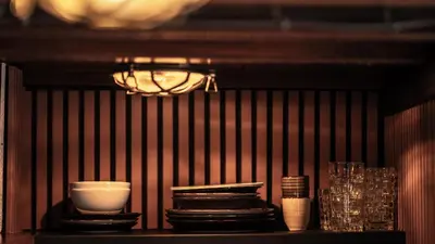 a shelf with plates and bowls and a chandelier at Houseboat-Amsterdam-Classic in Amsterdam