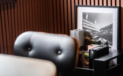 a chair in a room with a picture of a ship at Houseboat-Amsterdam-Classic in Amsterdam