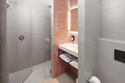 a bathroom with a shower and a sink at Boutique Hotel Brasa Beemster in Middenbeemster