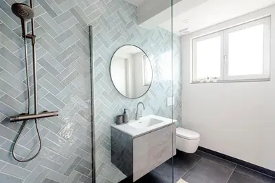 a bathroom with a sink and a mirror at Windhoek Apartment in Zandvoort