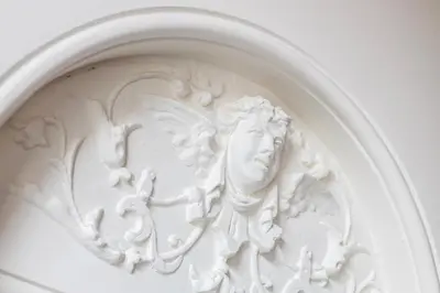a white statue of a man with wings on a wall at Edam Suites in Edam