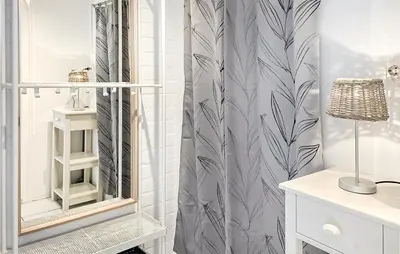 a bathroom with a shower curtain and a mirror at 3 Bedroom Stunning Home In Dirkshorn in Dirkshorn