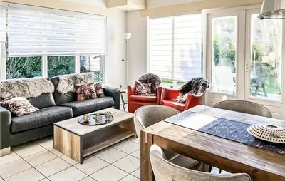 a living room with a couch and a table at 3 Bedroom Stunning Home In Dirkshorn in Dirkshorn