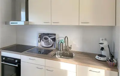 a kitchen with a sink and a counter top at 3 Bedroom Stunning Home In Dirkshorn in Dirkshorn