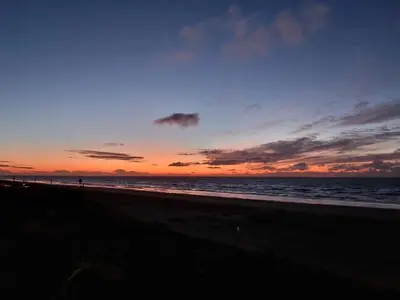 a sunset on a beach with the ocean at Beach & Sea view in Zandvoort