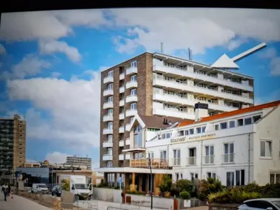 a tall white building in front of a building at Beach & Sea view in Zandvoort