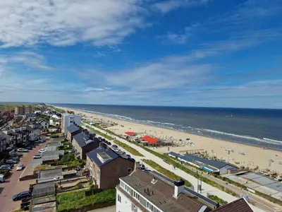 a view of a beach with buildings and the ocean at Beach & Sea view in Zandvoort