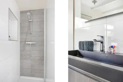 a bathroom with a sink and a shower at Quiet Waterloft near Amsterdam and Schiphol WS17 in Aalsmeer