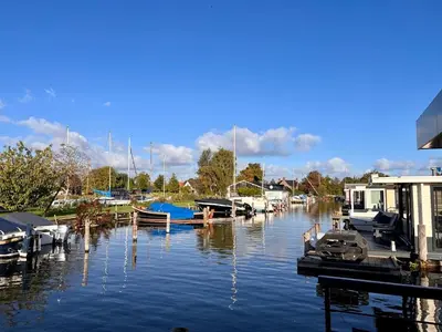a group of boats docked at a marina on the water at Quiet Waterloft near Amsterdam and Schiphol WS11 in Aalsmeer