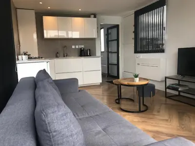 a living room with a couch and a table at Quiet Waterloft near Amsterdam and Schiphol WS11 in Aalsmeer