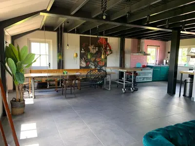 a large room with tables and chairs in it at Luxe in stiltegebied tussen loslopende Alpaca’s in Eemdijk