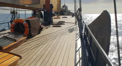 a wooden deck of a boat in the water at Boutique style ship 10 double cabins in Monnickendam