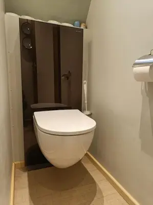 a bathroom with a white toilet in a room at Boutique style ship 10 double cabins in Monnickendam