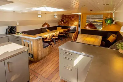 a restaurant with tables and chairs in a room at Boutique style ship 10 double cabins in Monnickendam