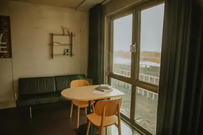 a table and chairs in a room with a window at Hotel Jansen Amsterdam Bajeskwartier in Amsterdam