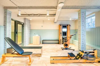 a gym with several exercise equipment in a room at Citadines Canal Amsterdam in Amsterdam