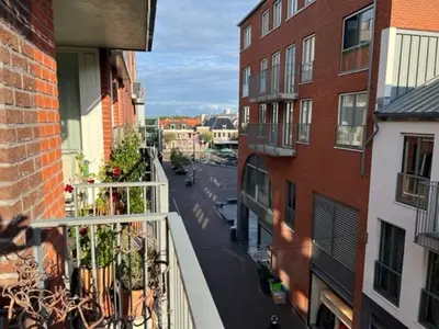 a view of a city street from a balcony at center appartement 2 rooms in Alphen aan den Rijn