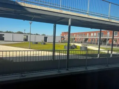 a view of an empty parking lot with a bridge at center appartement 2 rooms in Alphen aan den Rijn