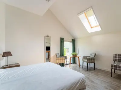 a bedroom with a bed and a table and chairs at Farmhouse with terrace in Montfoort in Montfoort