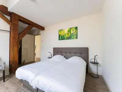 a bedroom with a large bed with white sheets at Farmhouse with terrace in Montfoort in Montfoort