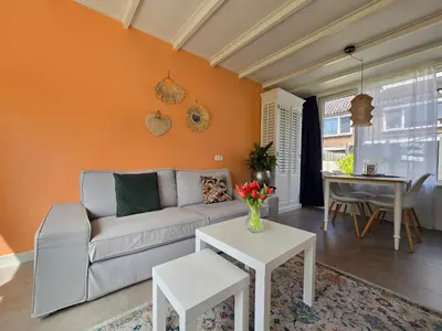 a living room with a couch and a table at De Witte Vos in Egmond aan Zee