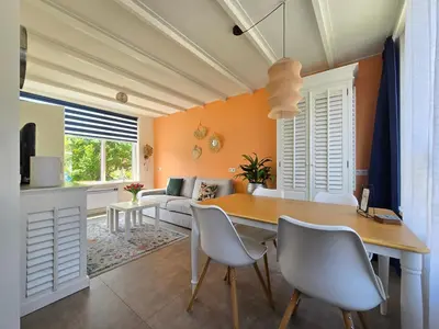 a kitchen and living room with a table and chairs at De Witte Vos in Egmond aan Zee