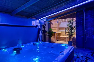 a blue bathroom with a tub in a room at Villa Savannah in Roelofarendsveen