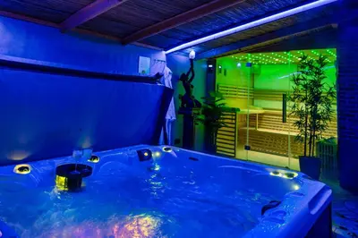 a blue bathroom with a tub in a room at Villa Savannah in Roelofarendsveen
