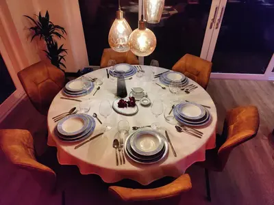 a table with plates and utensils on it at Villa Savannah in Roelofarendsveen