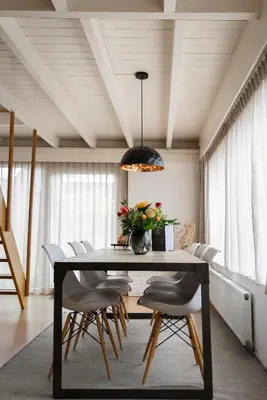 a dining room with a table and chairs at - Het Kleine Nest - nabij het meer, strand & Keukenhof in Noordwijkerhout