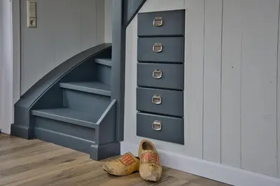 a pair of shoes in a room with drawers at Het Gouwe Boetje in Hoogwoud