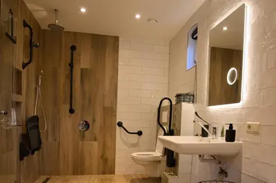 a bathroom with a sink and a toilet and a shower at Het Gouwe Boetje in Hoogwoud