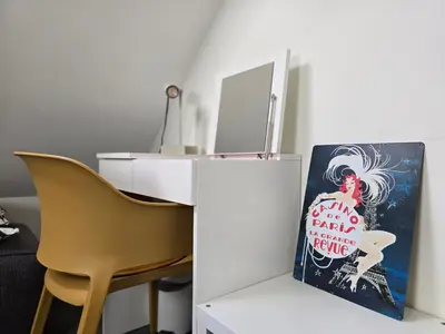 a desk with a book on it next to a chair at ZeeZuid in Egmond aan Zee