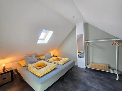 a bedroom with a bed with two pillows on it at ZeeZuid in Egmond aan Zee