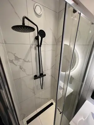 a shower with a glass door in a bathroom at Boutique Hotel de Kade Zaandam-Amsterdam in Zaandam