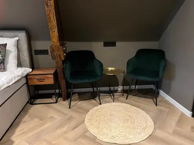 two green chairs and a table in a room at Boutique Hotel de Kade Zaandam-Amsterdam in Zaandam