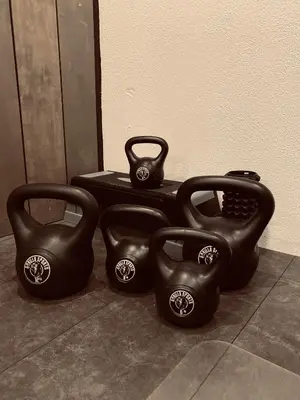 three black vases sitting on the floor next to a wall at By Balu in Soest