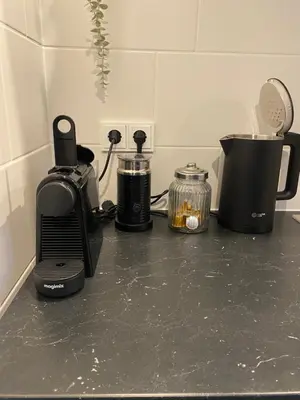 a counter top with a coffee maker and a blender at By Balu in Soest