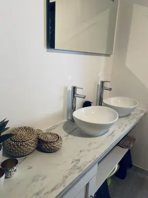 a bathroom with two white sinks on a counter at By Balu in Soest