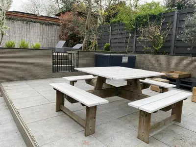 a picnic table and benches on a patio at By Balu in Soest