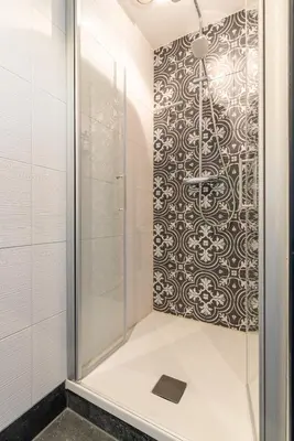 a bathroom with a shower with a glass door at Bed and Breakfast Geliefd in Voorhout