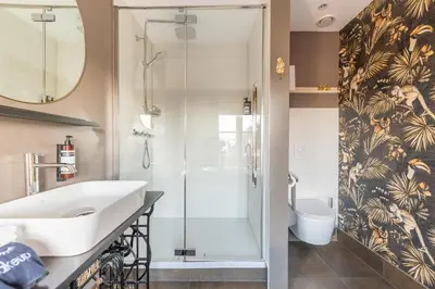 a bathroom with a sink and a shower at Bed and Breakfast Geliefd in Voorhout