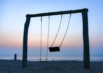 an empty swing on the beach at sunset at Bed and Breakfast Geliefd in Voorhout